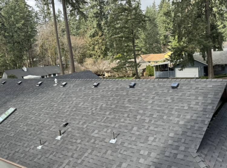 side view of a house with new grey roofing shingles