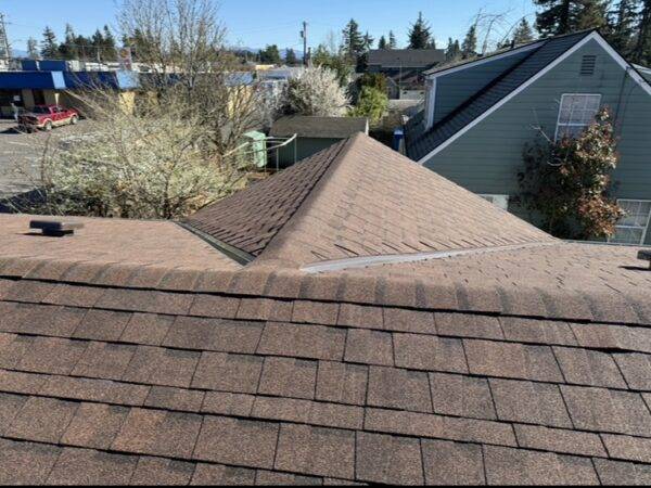 new brown roofing shingles on a roof ridge